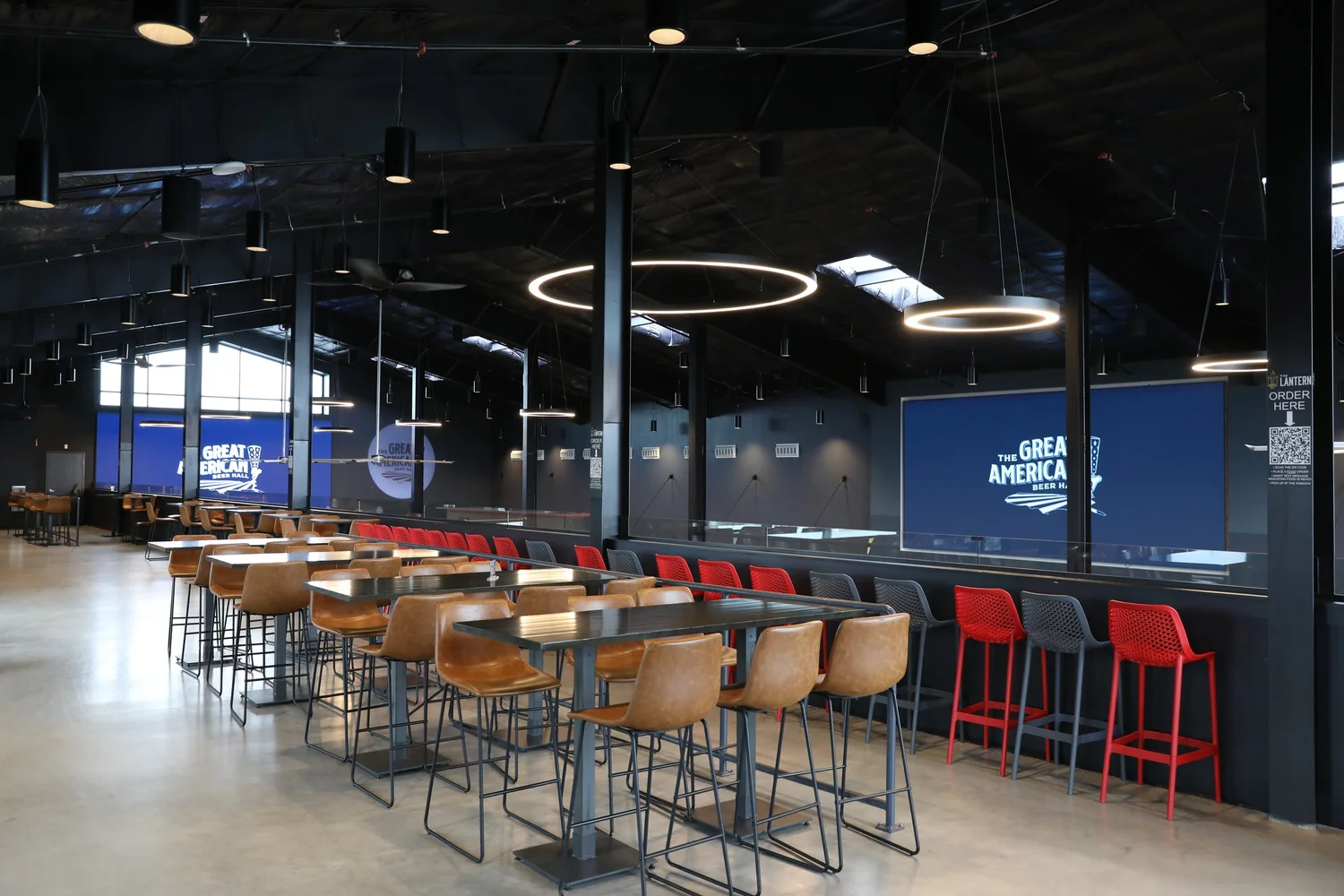 High-top tables and seating overlooking the hall