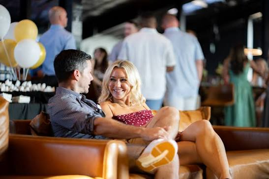 Two guests relaxing together on lounge seating during a celebration at the hall